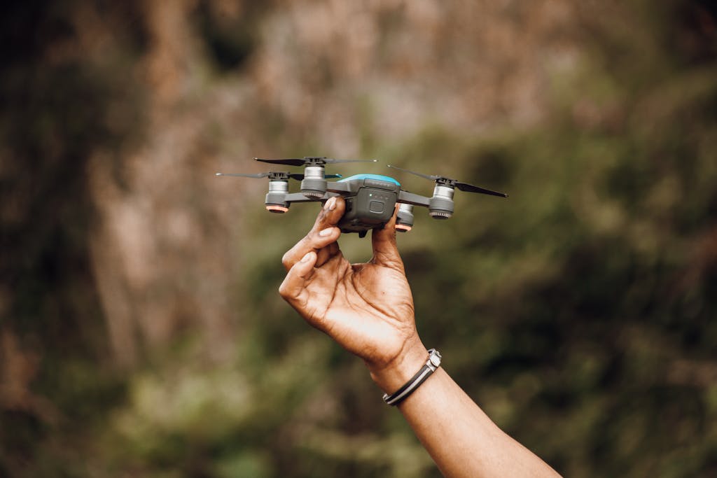Crop person showing drone in daytime outdoors